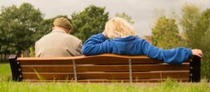 older couple sitting on a bench