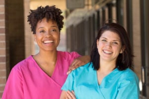 Two nursing smiling