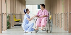 Nurse assisting elderly woman