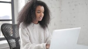African-American Woman sitting in front of a computer working