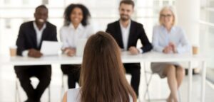 Woman sitting across from four other people