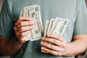 Hands holding dollar bills